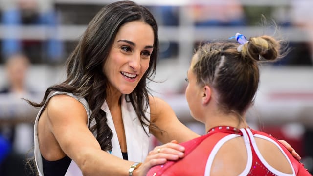 Arkansas gymnastics coach Jordyn Wieber talks things over during a meet at Barnhill Arena against Auburn.
